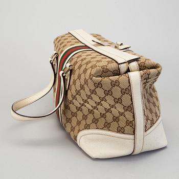 A Gucci canvas and leather hand bag.