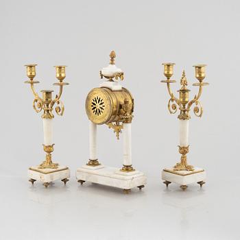 A Louis XVI-style mantel clock Paris, France and a pair of candelabras, late 19th century.