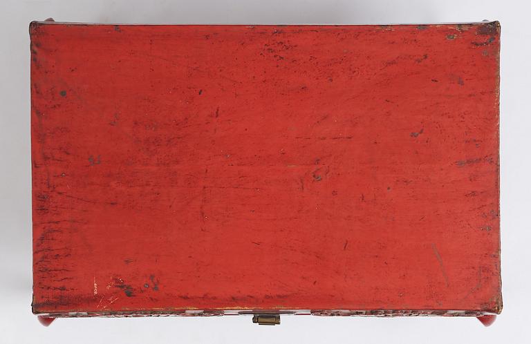 A red lacquered chest on a later stand, late Qing dynasty, 19th Century.