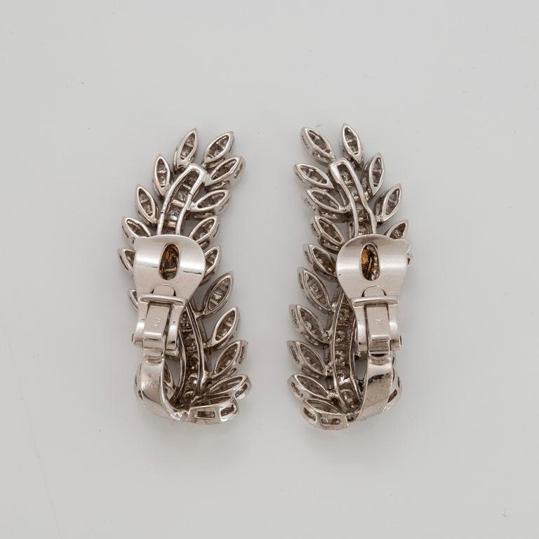 A pair of 18K white gold earrings set with round brilliant-cut diamonds.