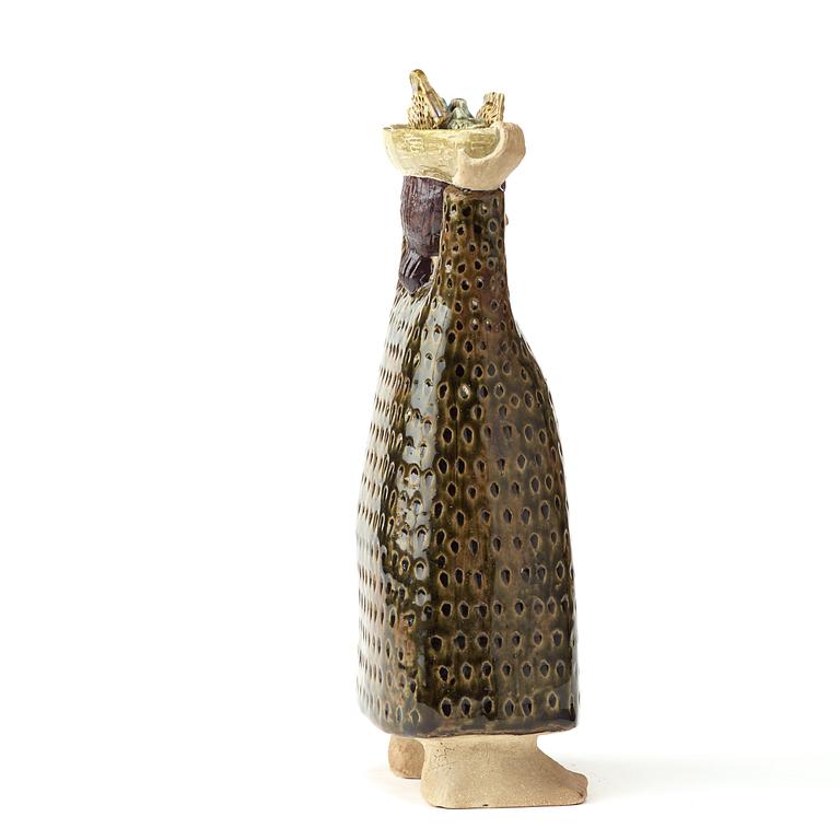 A stig Lindberg stoneware sculpture av woman carrying a a basket of fish, Gustavsberg studio, Sweden probably 1960's.