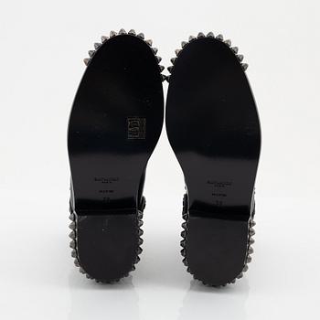 Yves Saint Laurent, a pair of black leather and studs boots, size 38.