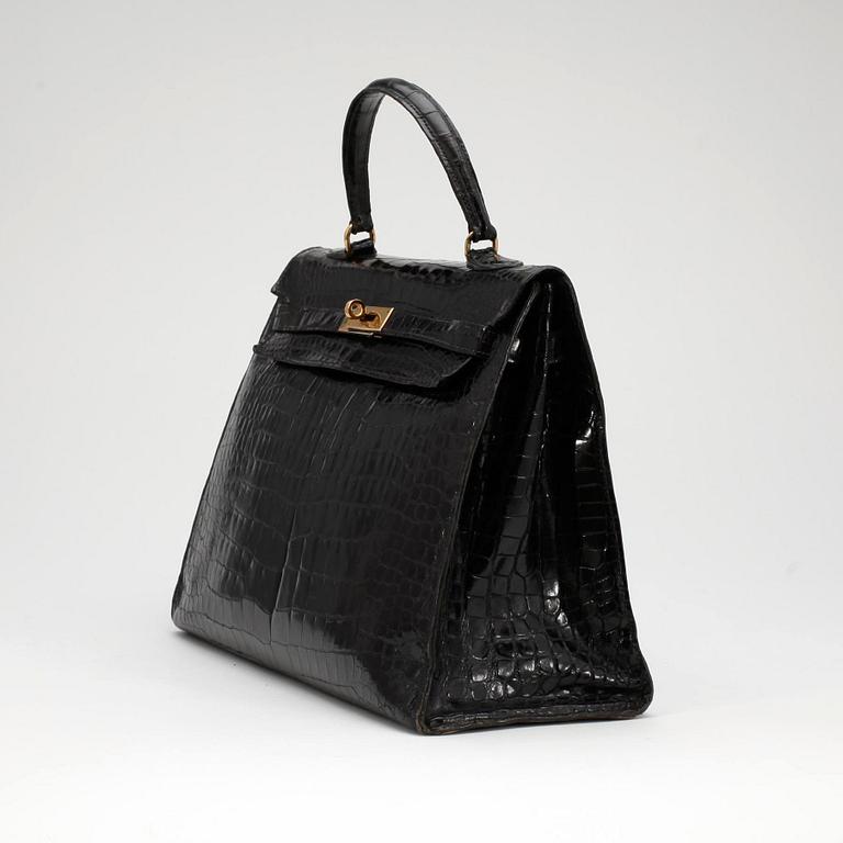 HERMÈS, a black crocodile "Kelly 35" bag from the 1960s.