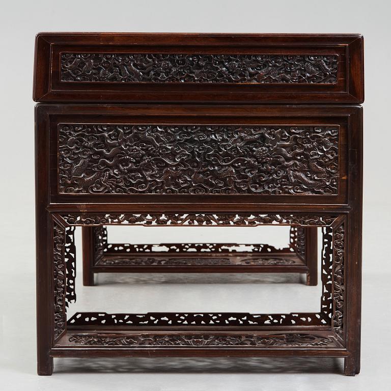 A carved hardwood desk, late Qing dynasty, circa 1900.