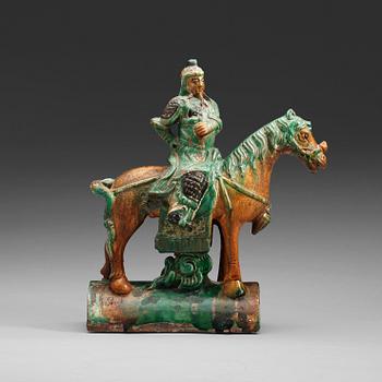 134. A green and brown glazed ridge tile figure of Guan Yu riding a horse, Ming dynasty  17th century.