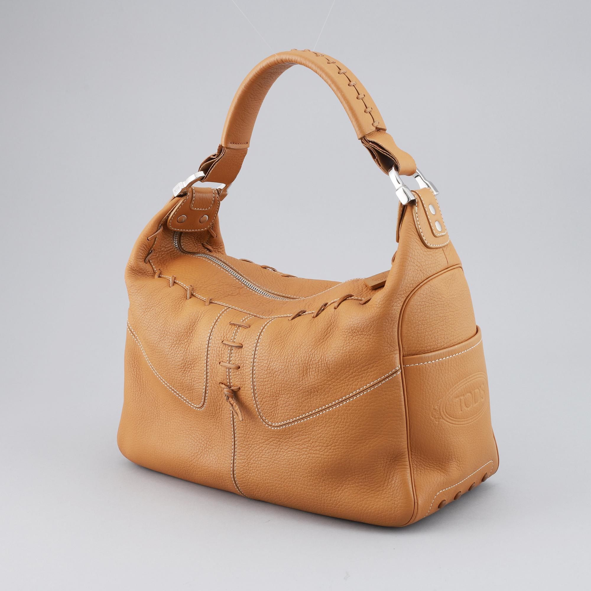 TOD'S, a tan leather bag.