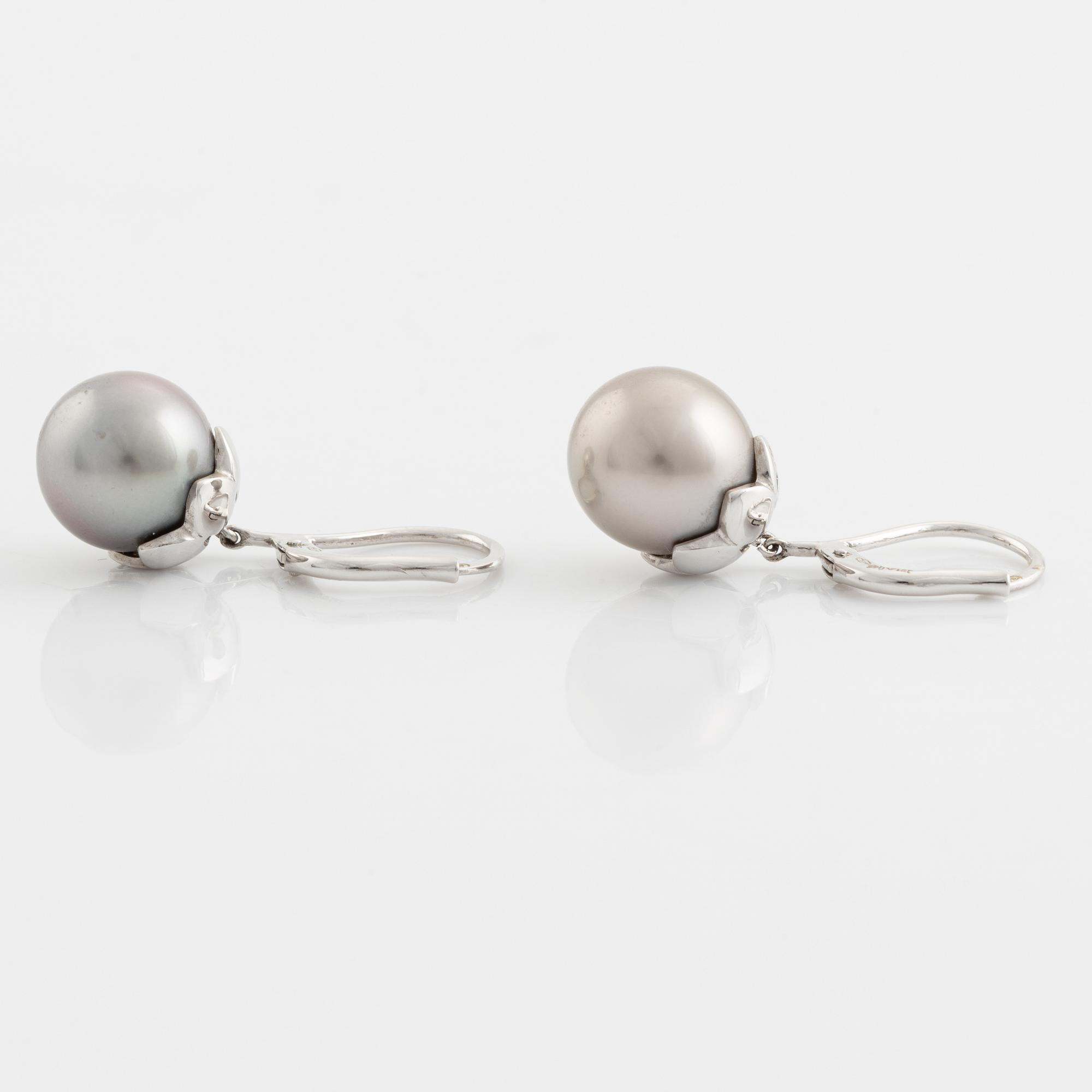 A pair of cultured pearl and brilliant cut diamond earrings.