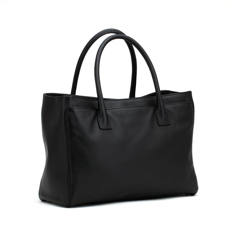 CHANEL,  a black leather bag.
