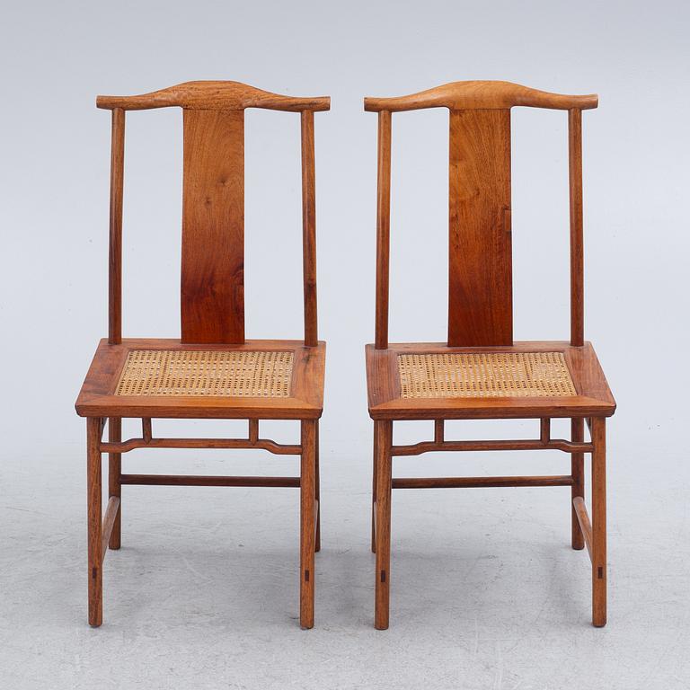 A Chinese hardwood dinner table and ten chairs with rattan seats, 20th century.