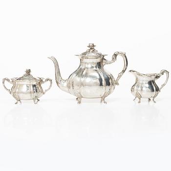 A Rococo style silver coffee pot, cream jug and sugar bowl, 20th century, Swedish import mark.