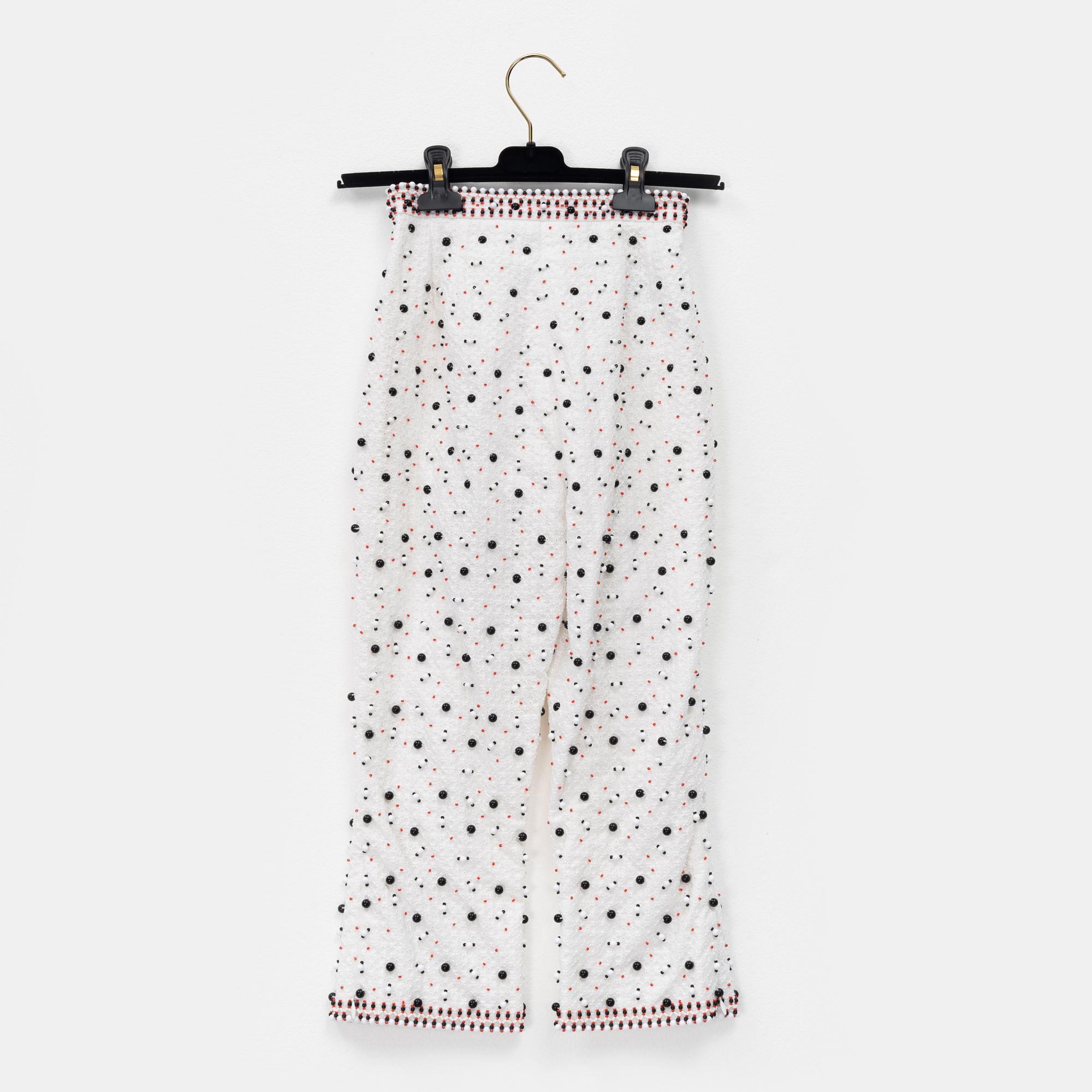 Chanel, a pair of broderie anglais trousers with pearls, size 34.