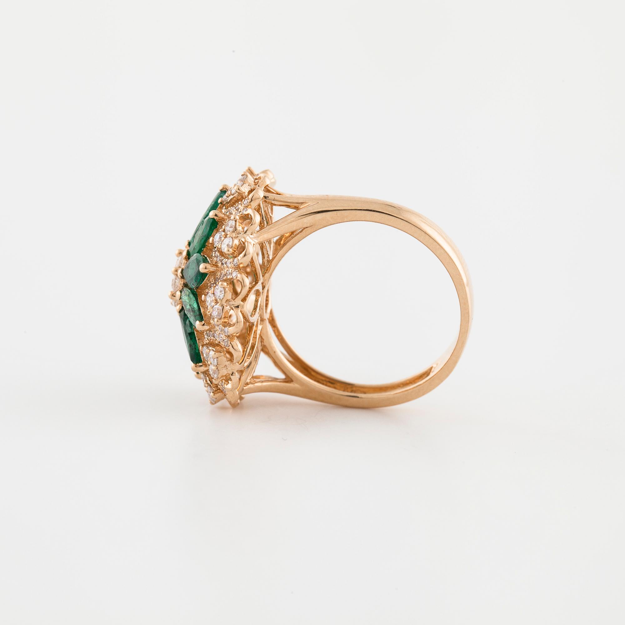 An marquise cut emerald and brilliant cut diamond ring.