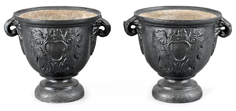 A pair of Baroque-style iron garden urns.