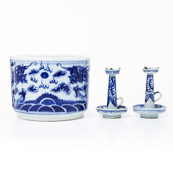 A pair of blue and white candle sticks and a brush pot, Qing dynasty, circa 1900.