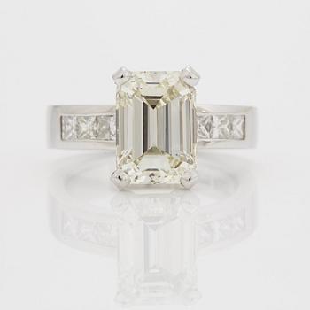 A RING set with an emerald-cut diamond.