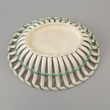 A CREAMWARE BASKET, PLATE AND A SIMILAR PLATE, one marked Wedgwood, first half of the 19th century.