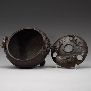 A bronze tripod censer with cover and stand, Qing dynasty, 17/18th Century.