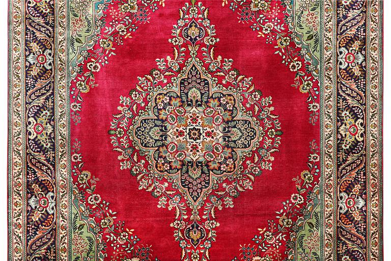 A Tabriz carpet, c. 330 x 250 cm.