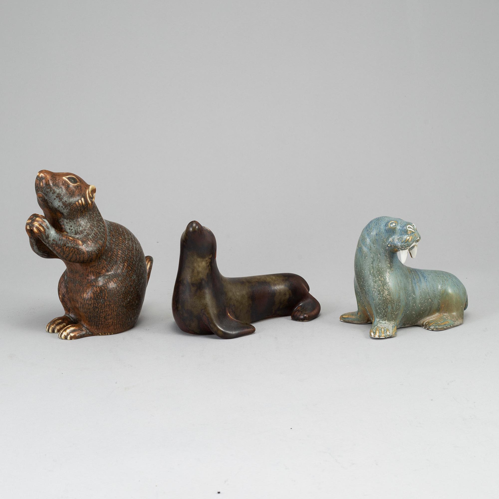GUNNAR NYLUND, a set of thre stoneware sculptures; a squirrel, a walrus and a seal, Rörstrand, Sweden.