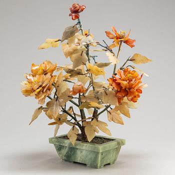 A stone flower pot with a flower made of stones, China, 20th Century.