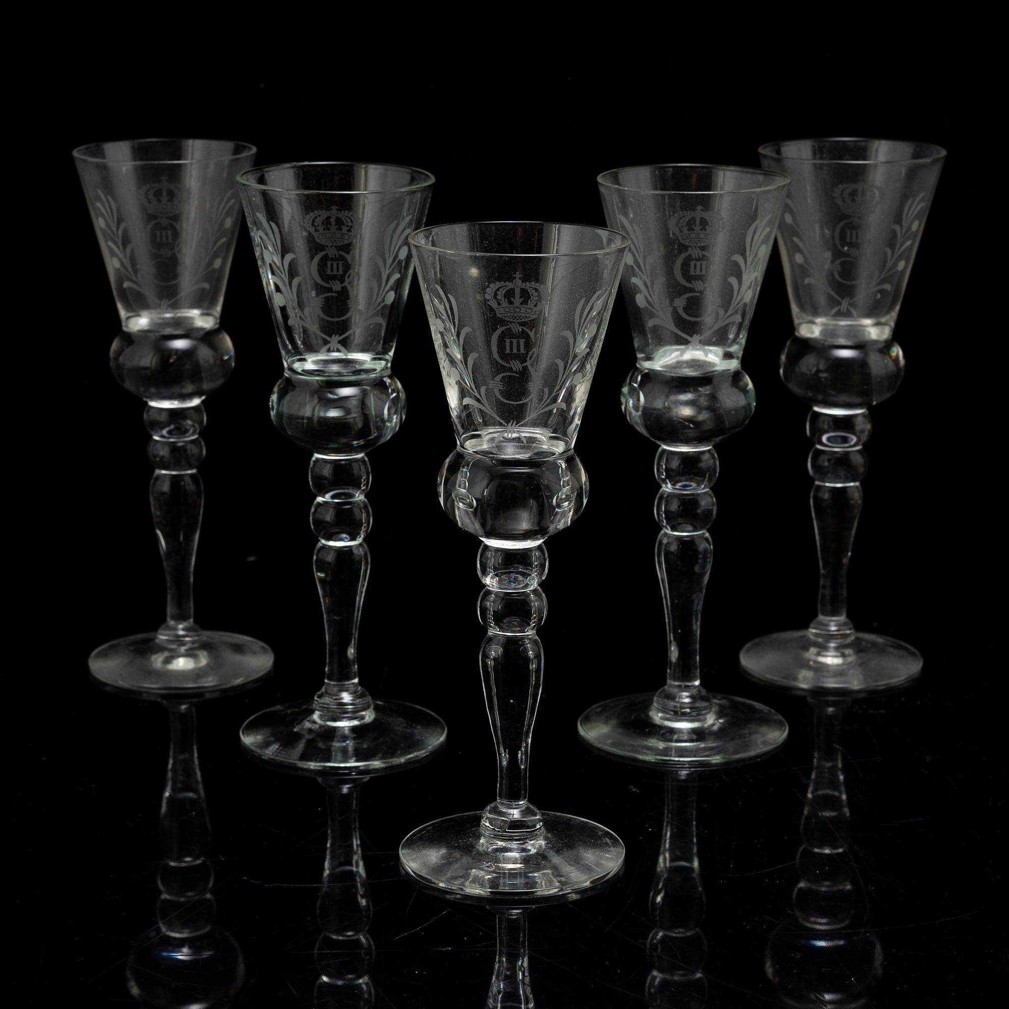A set of five snapps glasses and a snapps bottle, with Gustav III crowned monogram. 20th century, Baroque-style.