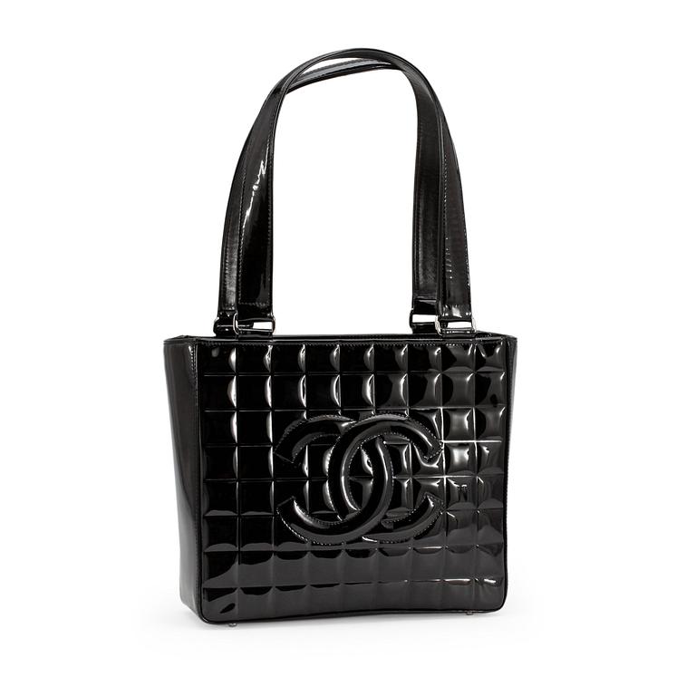 CHANEL, a quilted black patent leather top handle bag.