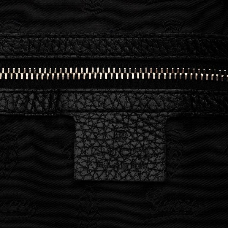 Gucci, a black neoprene handbag.