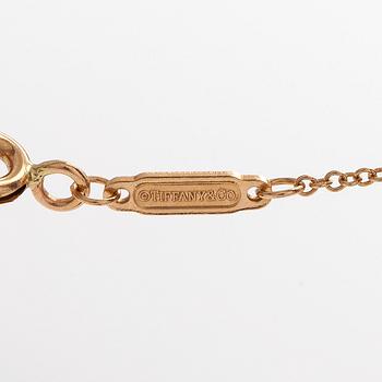 Tiffany & Co, an 18K gold 'T Smile' necklace.