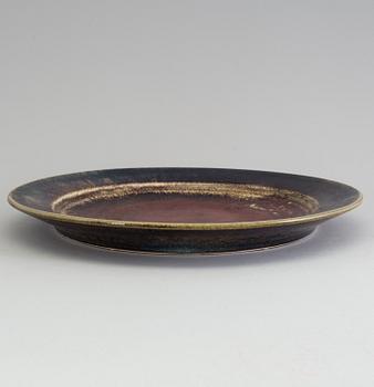 a 1960s stoneware plate designed by Stig Lindberg for Gustavsberg, signed.