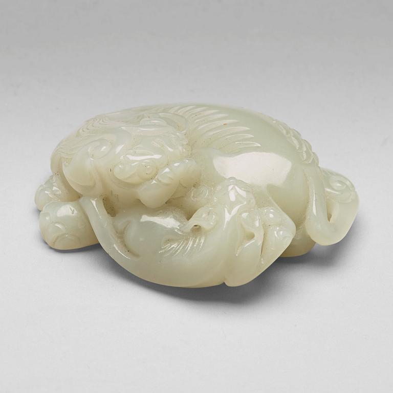 A Chinese nephrite figure of a reclining buddhist lion and its cub, presumably circa 1900.