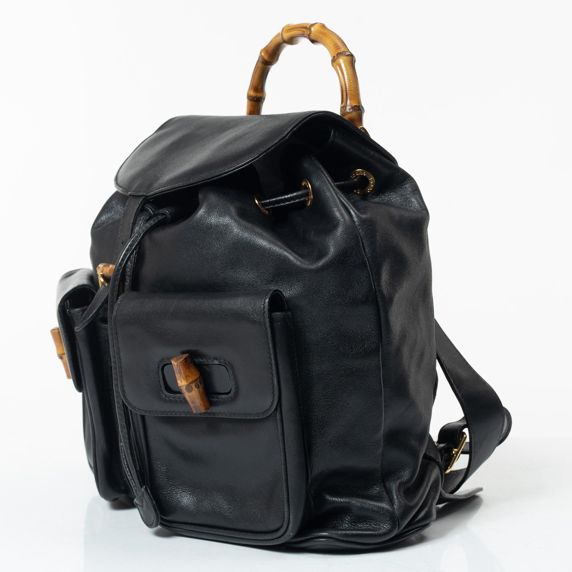 Gucci, A black leather backpack.