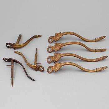 SEVEN BRONZE CURTAIN TIE-BACKS (4+3), 19th century.