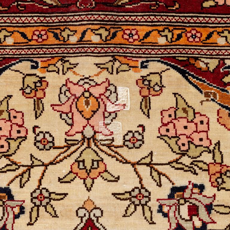 A Silk Hereke Rug, circa 86 x 68 cm.