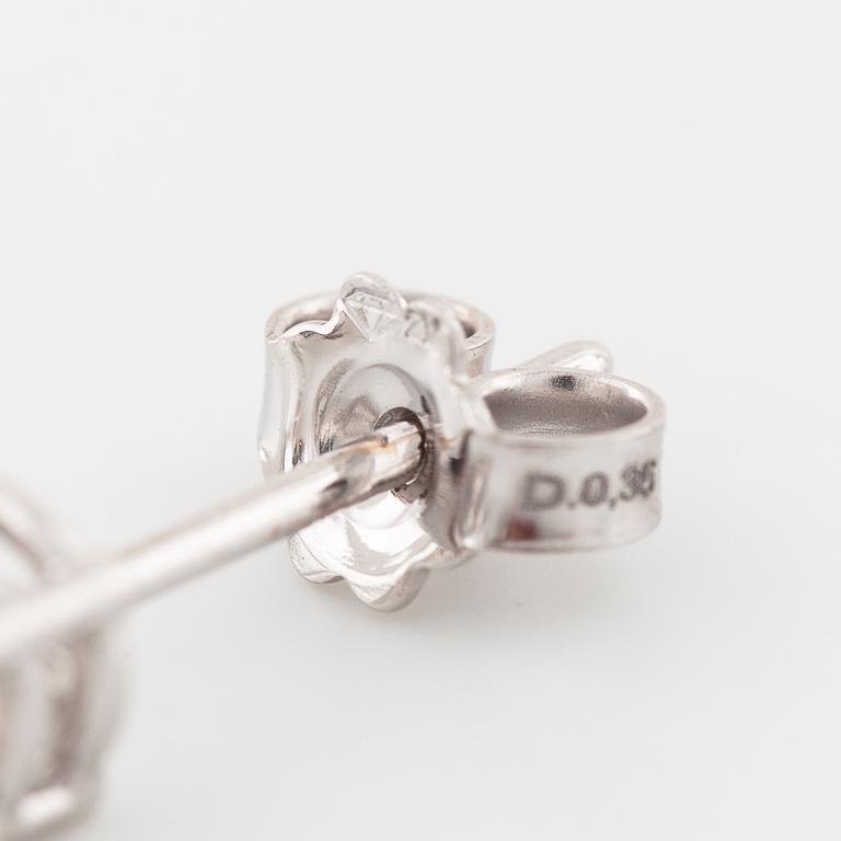 A pair of brilliant cut diamond earrings.
