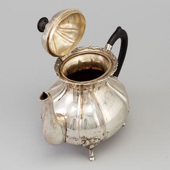 A silver rococo style teapot.