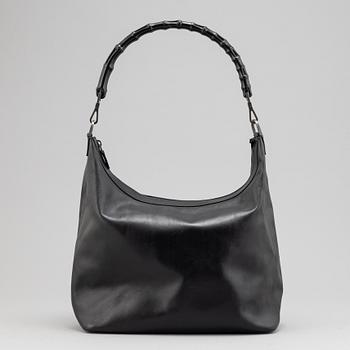 Gucci, a black leather handbag.