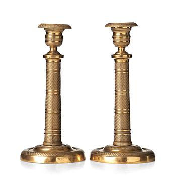 133. A pair of French Empire early 19th century candlesticks.