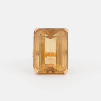 A ring set with a step-cut citrine.