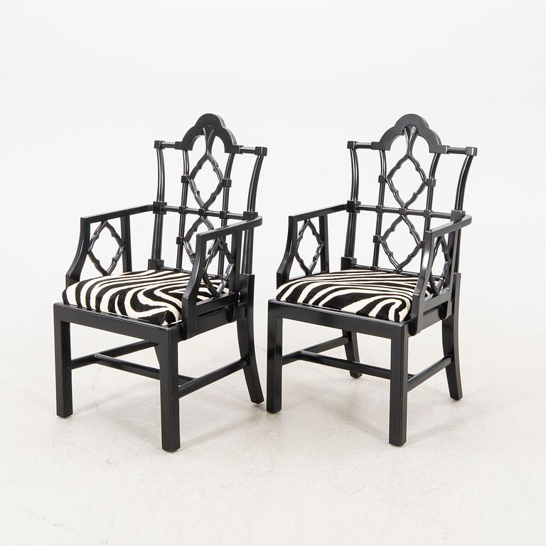 A pair of modern Eichholtz armchairs.