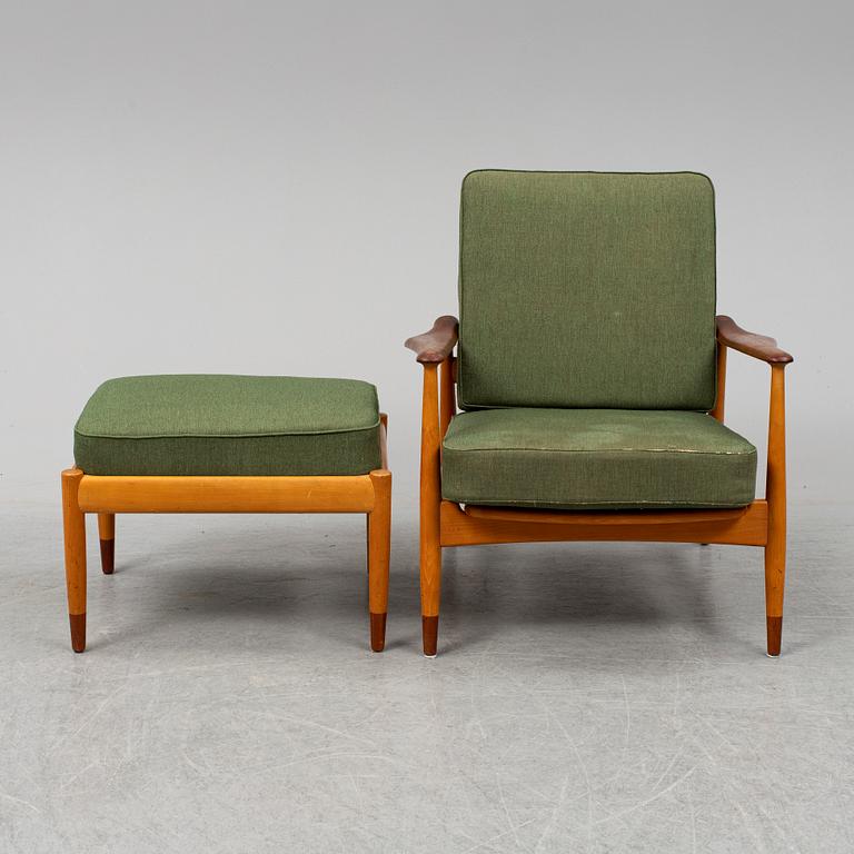 A 1950's beech and teak model FD 161 easy chair with stool by Arne Vodder for France & Son.