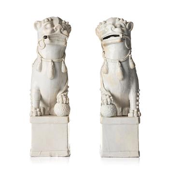 1281. A pair of Chinese blanc de Chine 'Buddhist lion' joss stick holders, Qing dynasty, Kangxi (1662-1722).