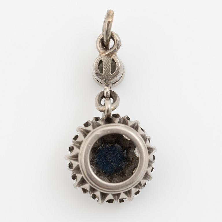 Pendant in 18K gold with a blue stone and diamonds.