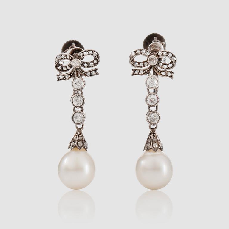 A pair of diamond, circa 0.70 ct, and probably cultured pearl earrings. Stockholm 1910.
