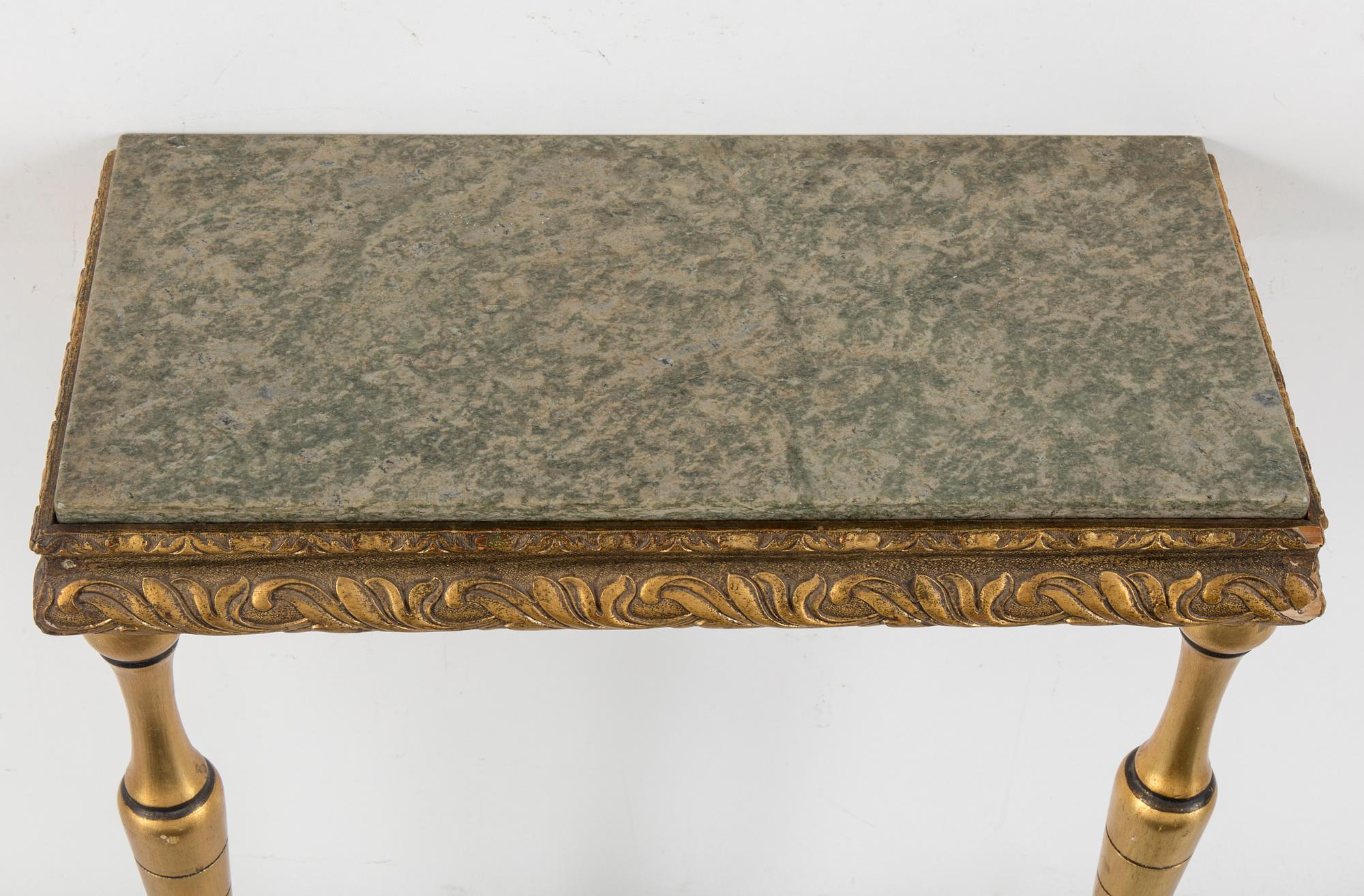 a bronzed mirror and a console table from the second half of the 20th century.