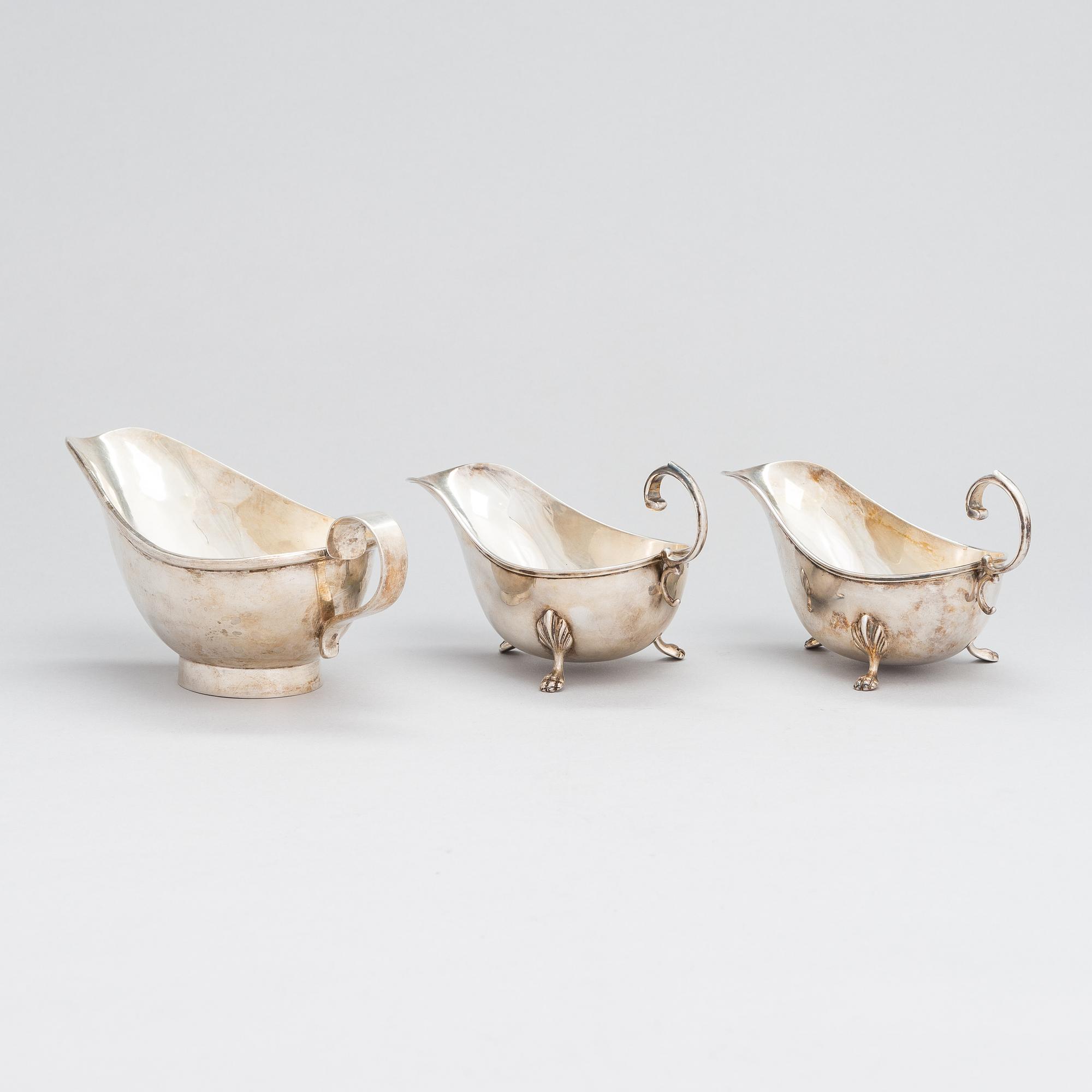 A pair of sauce jugs, maker's mark of Charles & George Asprey, London 1904, and 20th-century sauce jug. Sterling silver.