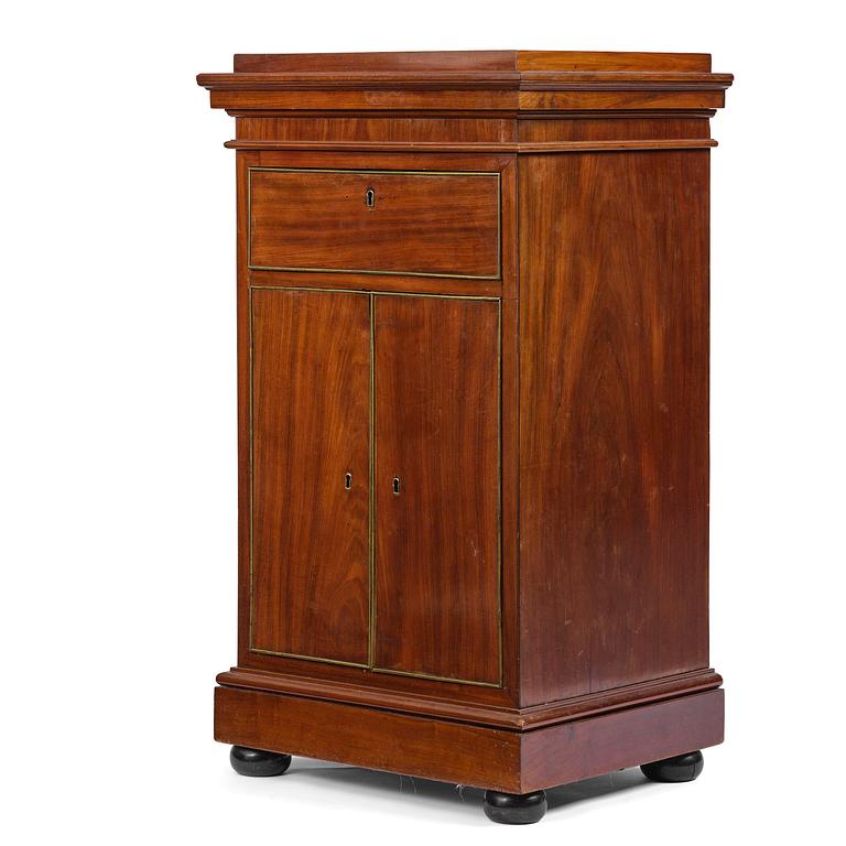 A late Gustavian mahogany column-cabinet, Stockholm, circa 1800.
