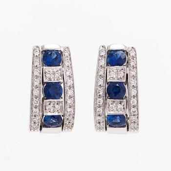 Earrings 18K white gold with faceted sapphires and round brilliant-cut diamonds.