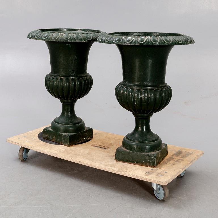 A pair of two 1990s cast iron garden urns.