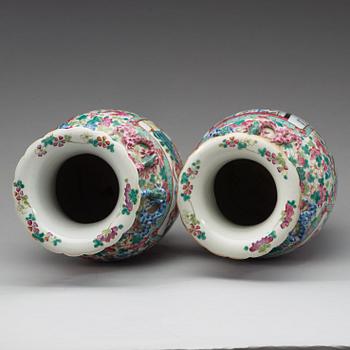 A pair of Canton famille rose vases, Qing dynasty, 19th Century.