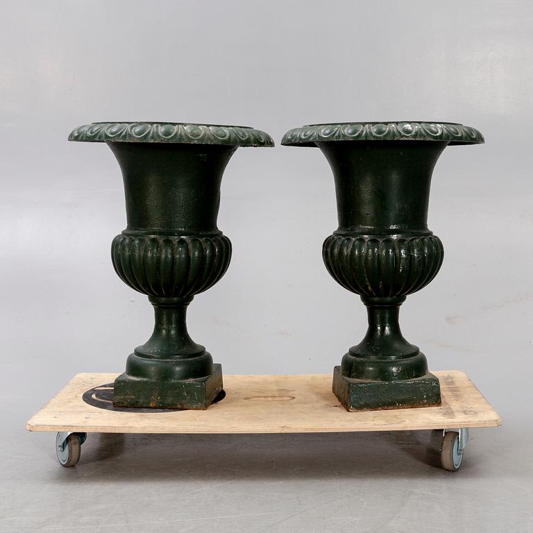 A pair of two 1990s cast iron garden urns.